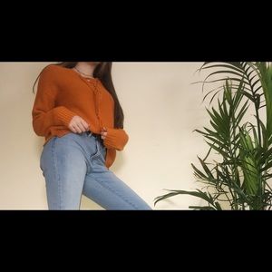 Knit orange sweater with tie up detailing